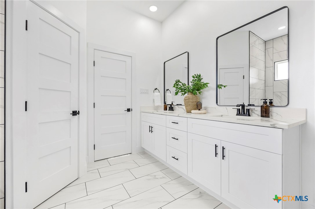 108 Skyline Road Georgetown, TX 78628 - Photo 22 of 48 a bathroom with a double vanity sink and mirror