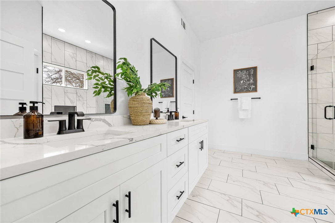 108 Skyline Road Georgetown, TX 78628 - Photo 23 of 48 a bathroom with a sink a mirror and a shower