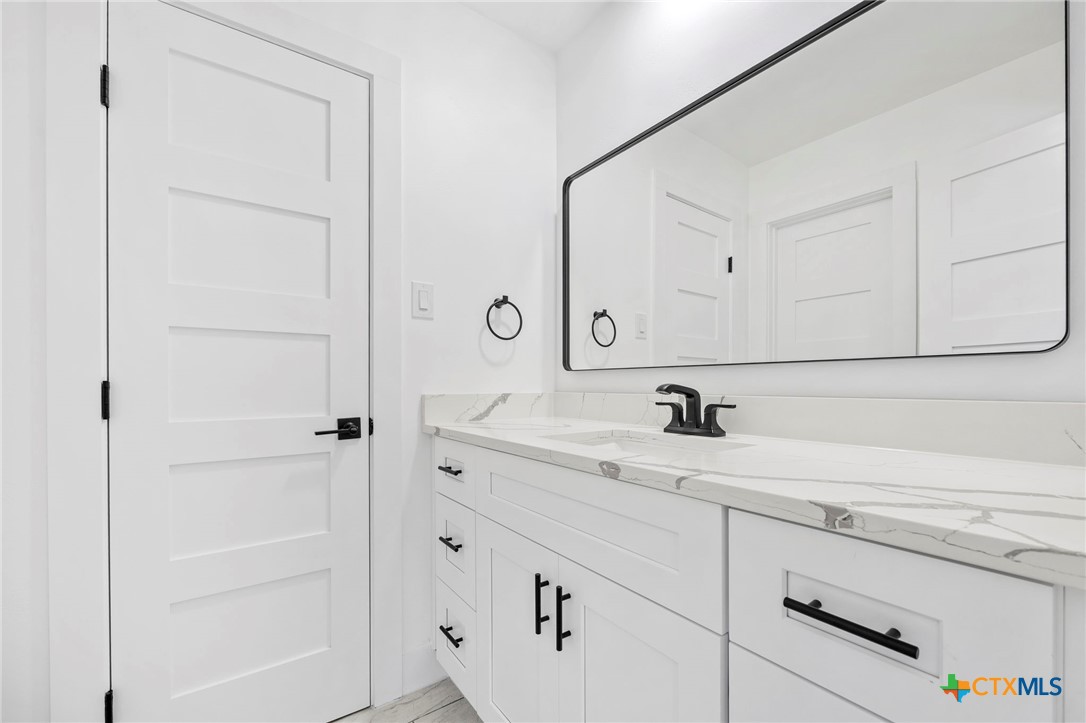 108 Skyline Road Georgetown, TX 78628 - Photo 28 of 48 a bathroom with a sink and a mirror