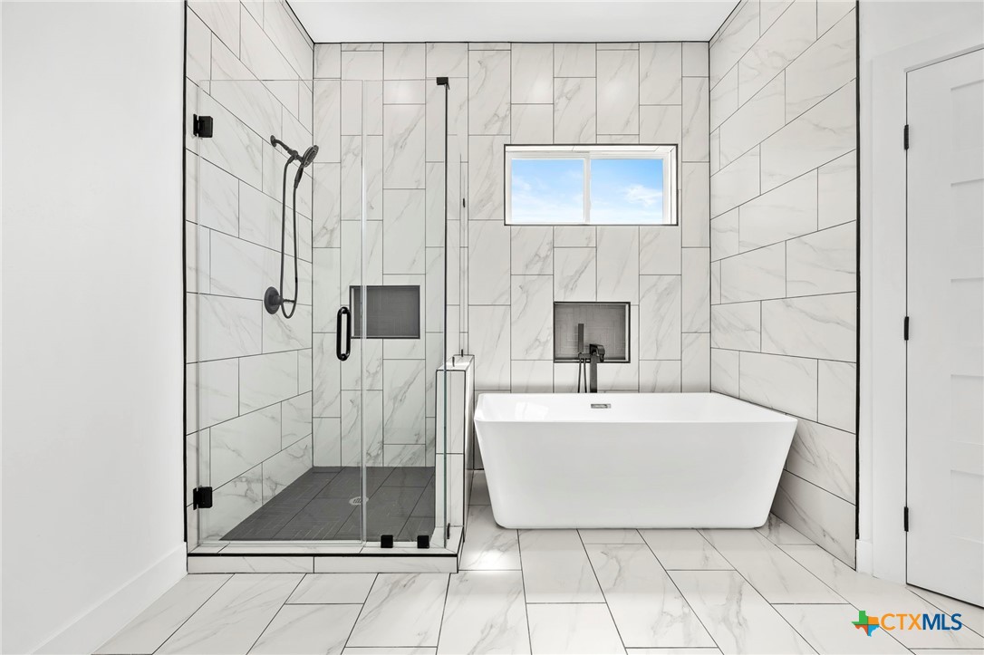 108 Skyline Road Georgetown, TX 78628 - Photo 4 of 48 a bathroom with a sink a shower and a mirror