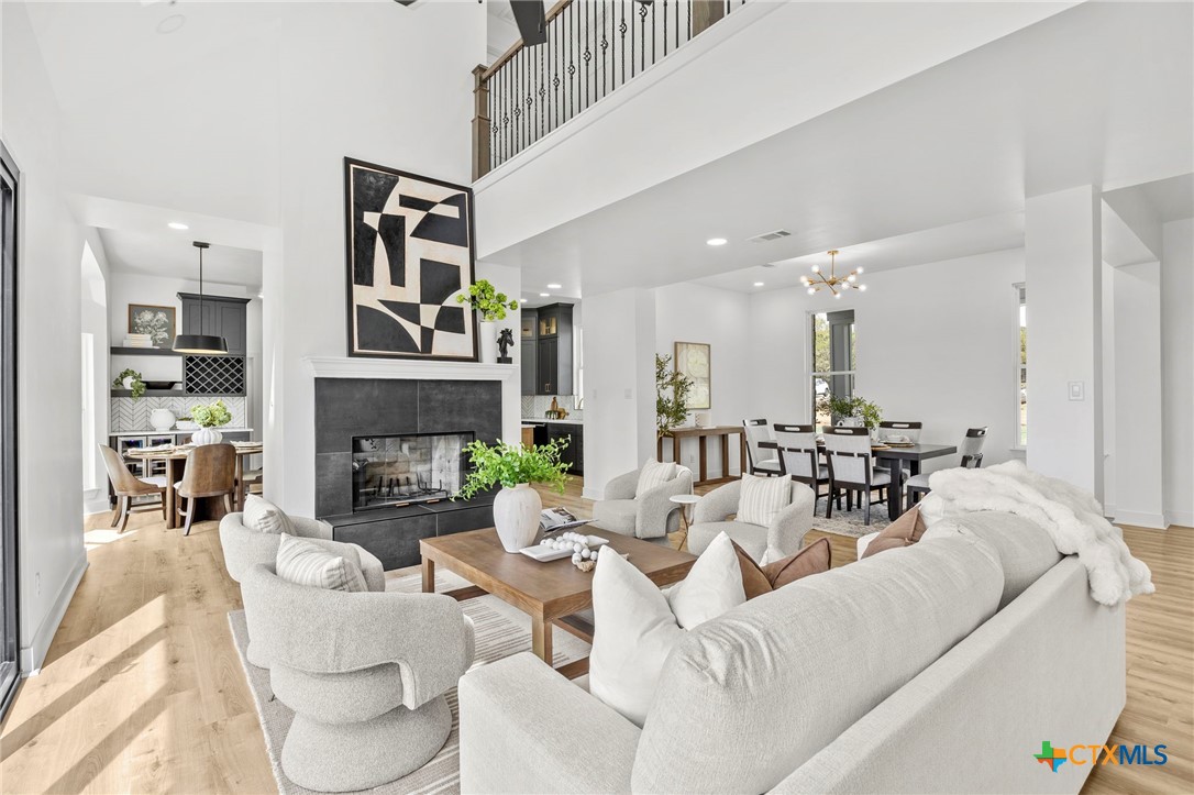 108 Skyline Road Georgetown, TX 78628 - Photo 10 of 48 a living room with furniture a fireplace and a chandelier