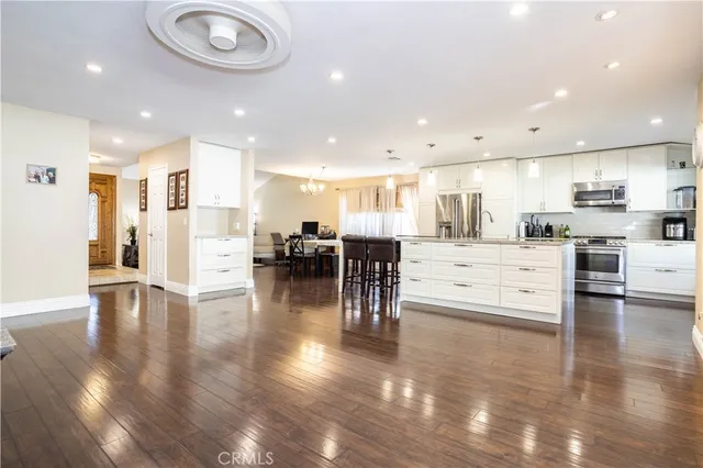 a view of a kitchen with a sink and refrigerator