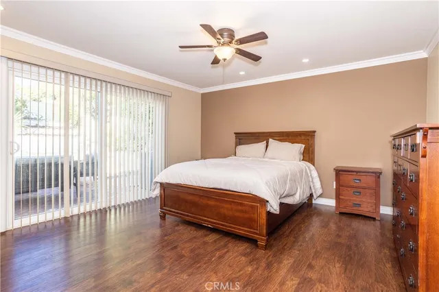 a spacious bedroom with a bed and a flat screen tv