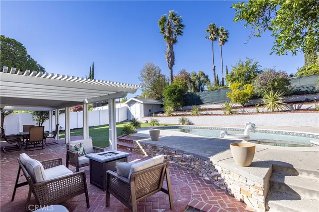 a view of a patio with table and chairs and potted plants