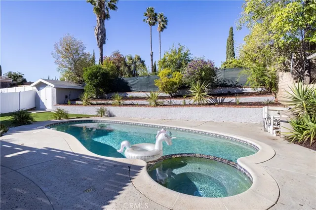 a view of a house with swimming pool and sitting area