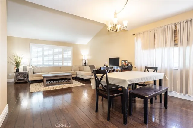 a living room with furniture a flat screen tv and kitchen view