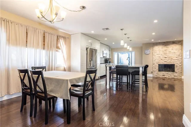 a living room with furniture wooden floor and a large window