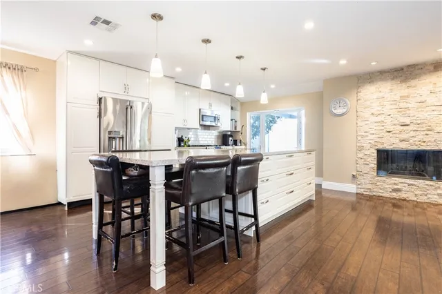 a view of kitchen with kitchen island and stainless steel appliances