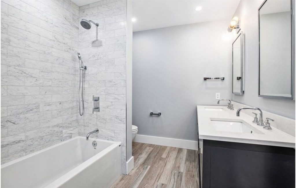131 Front Street, Unit 1 Scituate, MA 02066 - Photo 13 of 15 a bathroom with a sink mirror toilet and bathtub