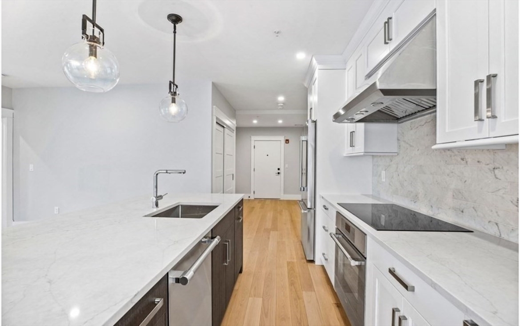 131 Front Street, Unit 1 Scituate, MA 02066 - Photo 4 of 15 a kitchen with a sink and a refrigerator