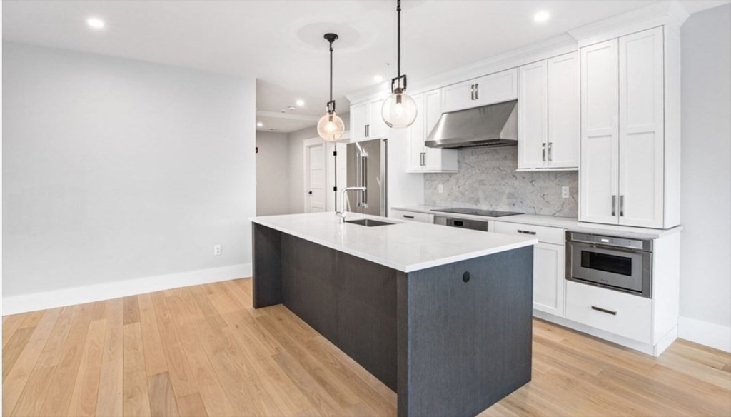 131 Front Street, Unit 1 Scituate, MA 02066 - Photo 6 of 15 a kitchen with a sink a stove and a refrigerator
