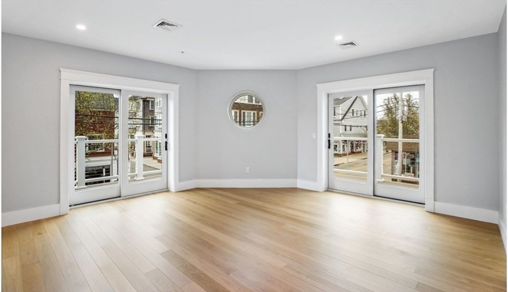 131 Front Street, Unit 1 Scituate, MA 02066 - Photo 7 of 15 a view of an empty room with a window and wooden floor