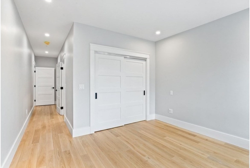 131 Front Street, Unit 1 Scituate, MA 02066 - Photo 9 of 15 wooden floor in an empty room with a window