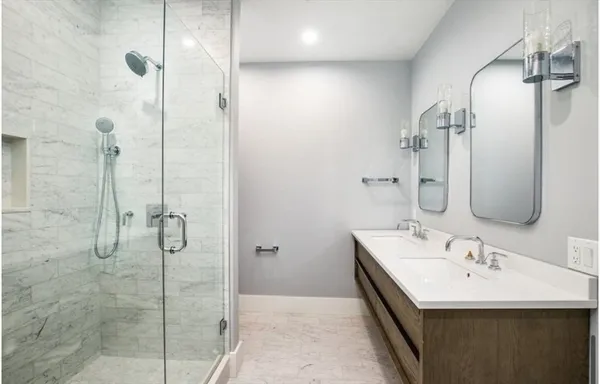 a bathroom with a double vanity sink a mirror and shower