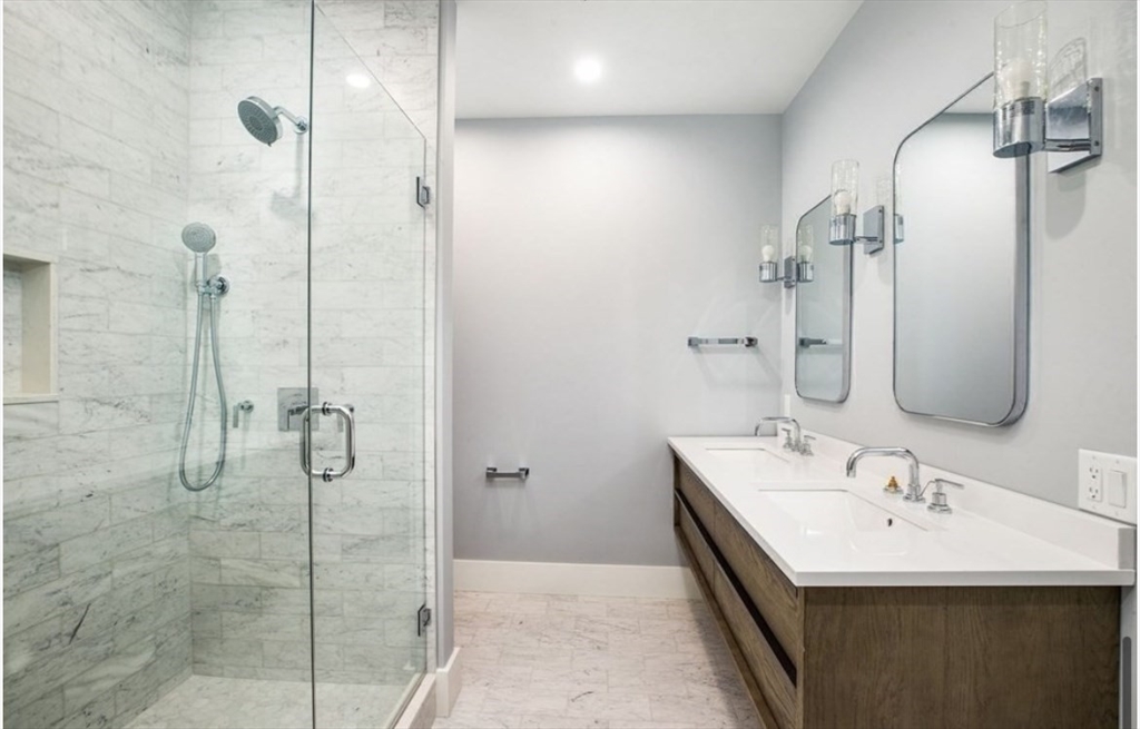 131 Front Street, Unit 1 Scituate, MA 02066 - Photo 10 of 15 a bathroom with a double vanity sink a mirror and shower