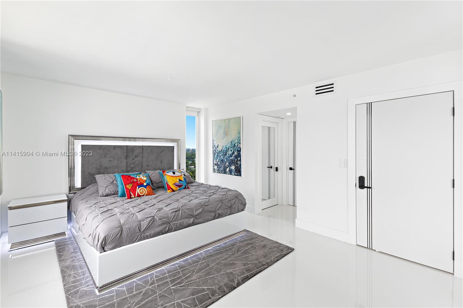 Miami Beach Miami Beach, FL 33139 - Photo 18 of 41 a bedroom with a bed and a dresser