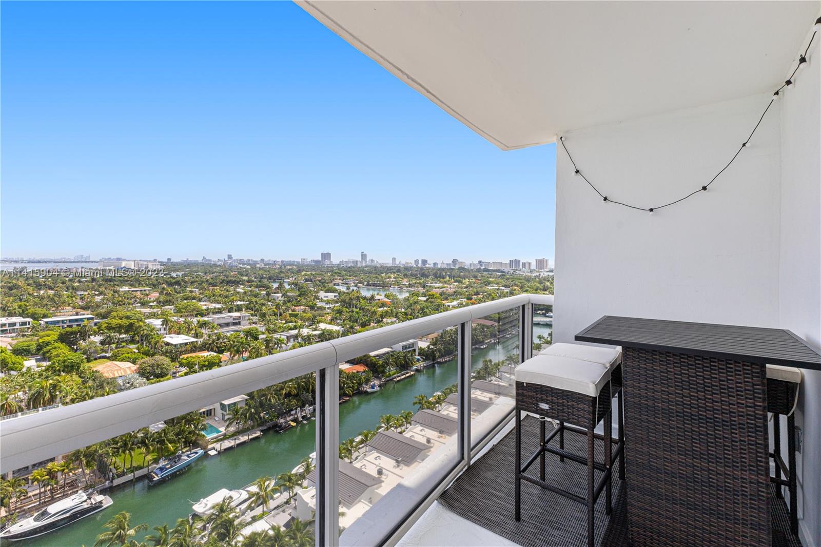 Miami Beach Miami Beach, FL 33139 - Photo 25 of 41 a view of a balcony with wooden floor and outdoor seating