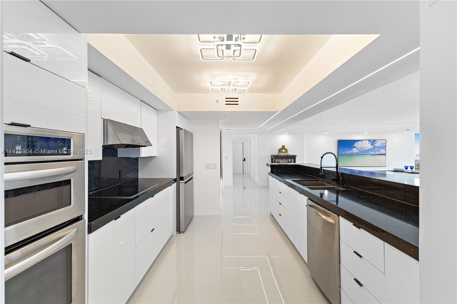 Miami Beach Miami Beach, FL 33139 - Photo 30 of 41 a kitchen with granite countertop stainless steel appliances a stove and cabinets