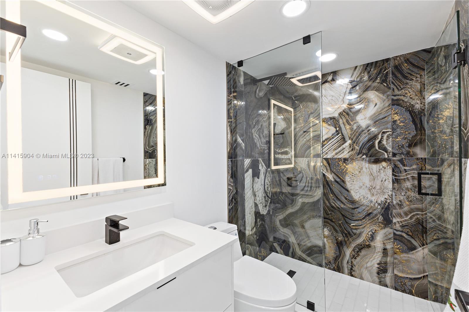 Miami Beach Miami Beach, FL 33139 - Photo 34 of 41 a bathroom with a sink toilet vanity and shower