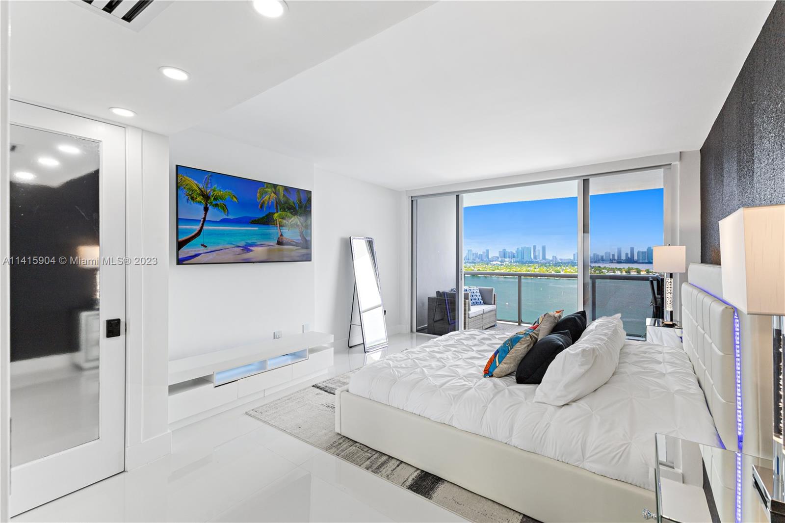 Miami Beach Miami Beach, FL 33139 - Photo 35 of 41 a bedroom with a bed and a painting on the wall