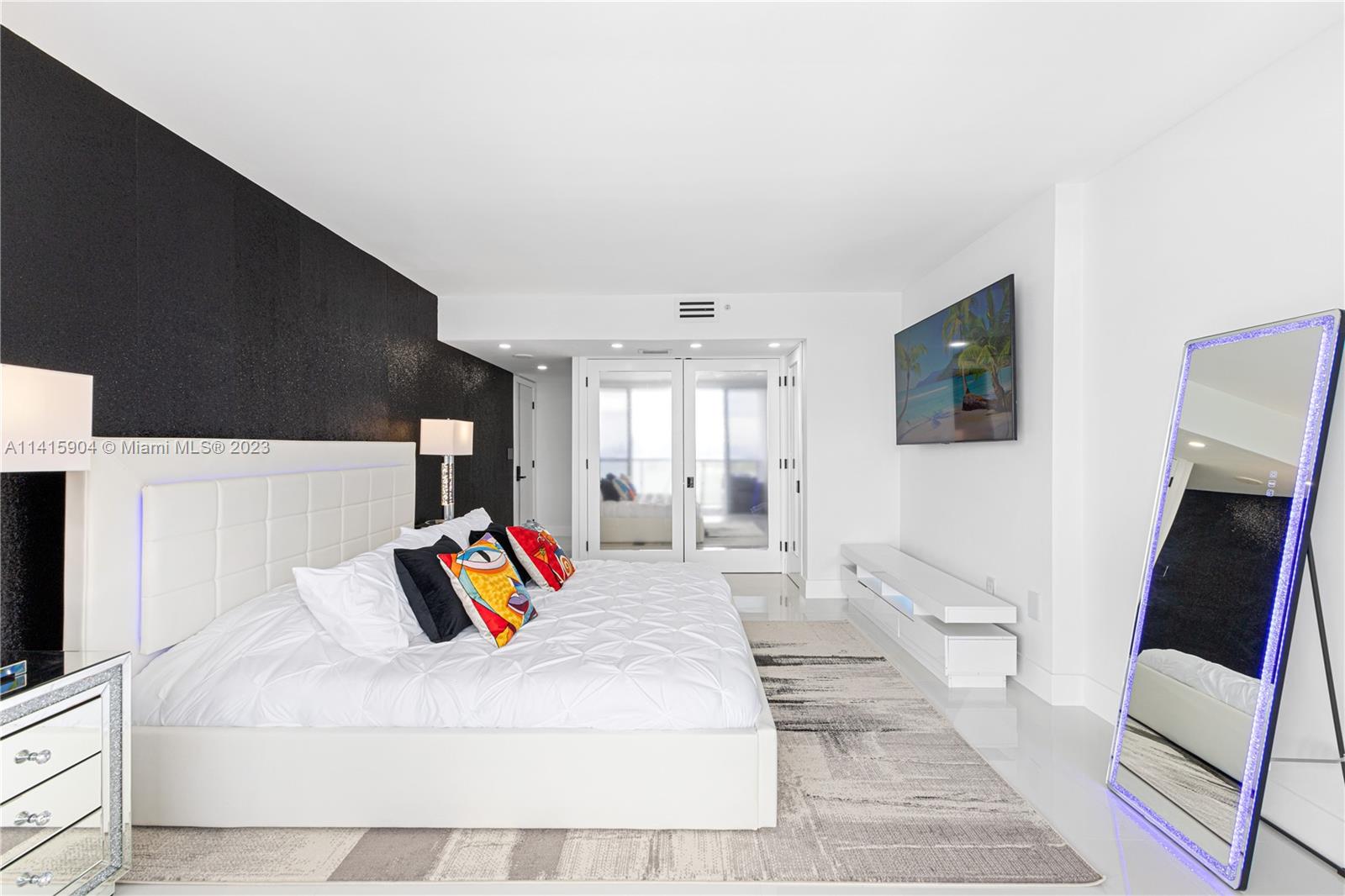 Miami Beach Miami Beach, FL 33139 - Photo 37 of 41 a spacious bedroom with a bed and a couch