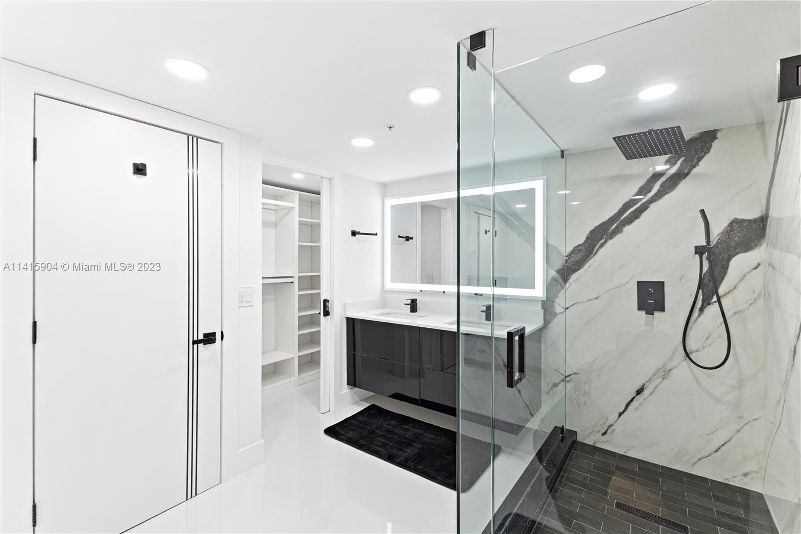 Miami Beach Miami Beach, FL 33139 - Photo 39 of 41 a bathroom with a tub sink shower and mirror