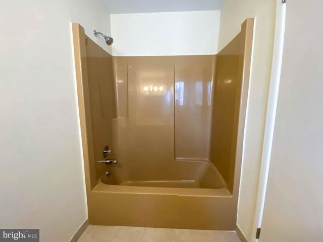 a bathroom with a bathtub and shower