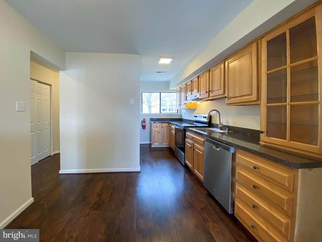 a kitchen with stainless steel appliances granite countertop a stove and a refrigerator
