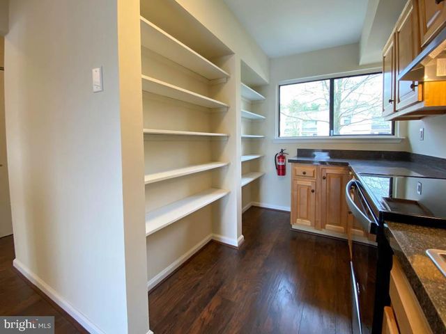 a room with wooden floors and a window