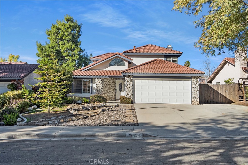 8747 Coyote Bush Road Riverside, CA 92508 - Photo 1 of 1 a front view of a house with a yard and garage