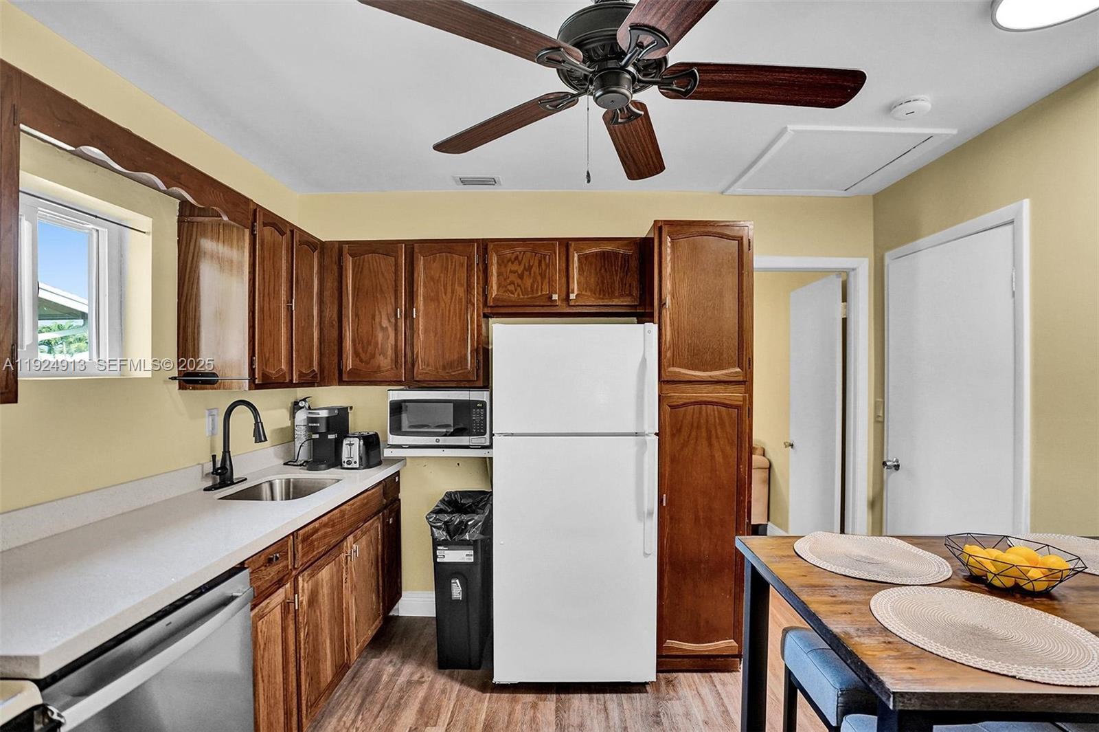 2620 Northeast 19th Street Pompano Beach, FL 33062 - Photo 11 of 42 a kitchen with a refrigerator a sink and dishwasher