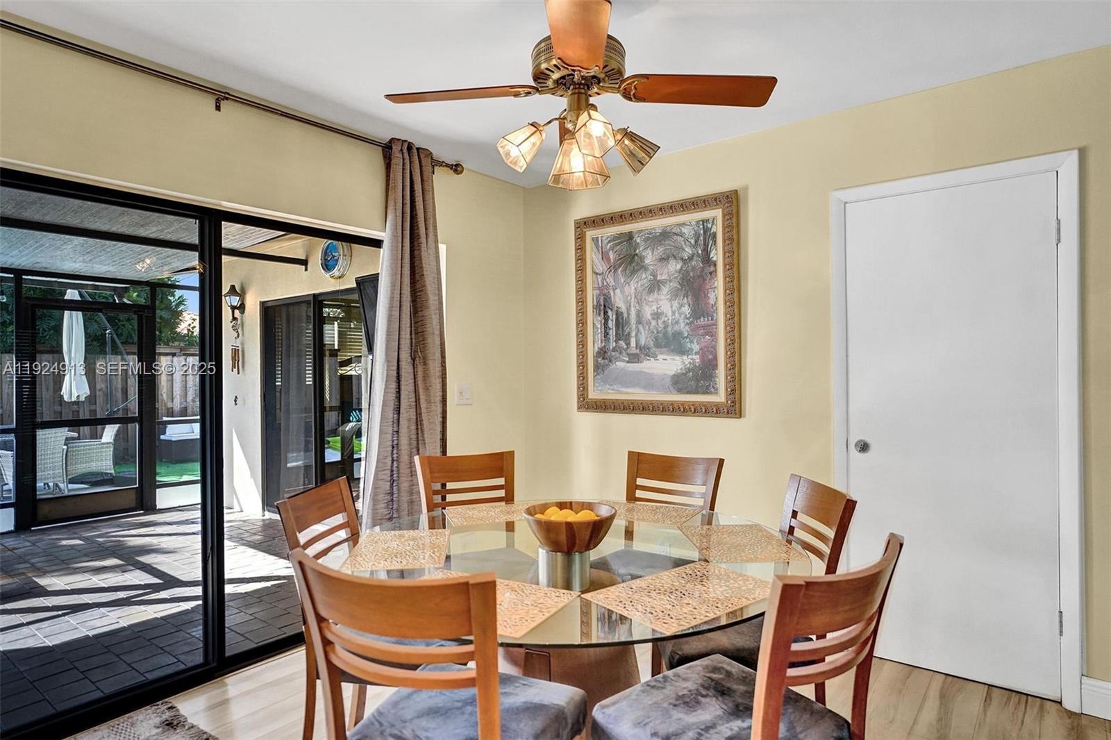 2620 Northeast 19th Street Pompano Beach, FL 33062 - Photo 16 of 42 a view of a dining room with furniture and chandelier
