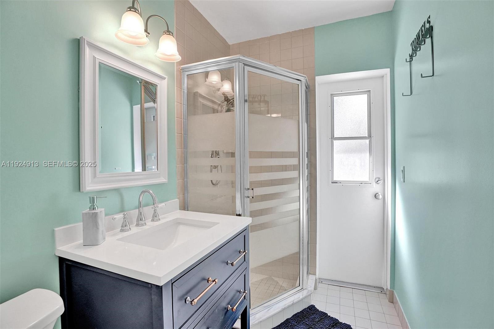 2620 Northeast 19th Street Pompano Beach, FL 33062 - Photo 17 of 42 a bathroom with a sink a toilet and shower