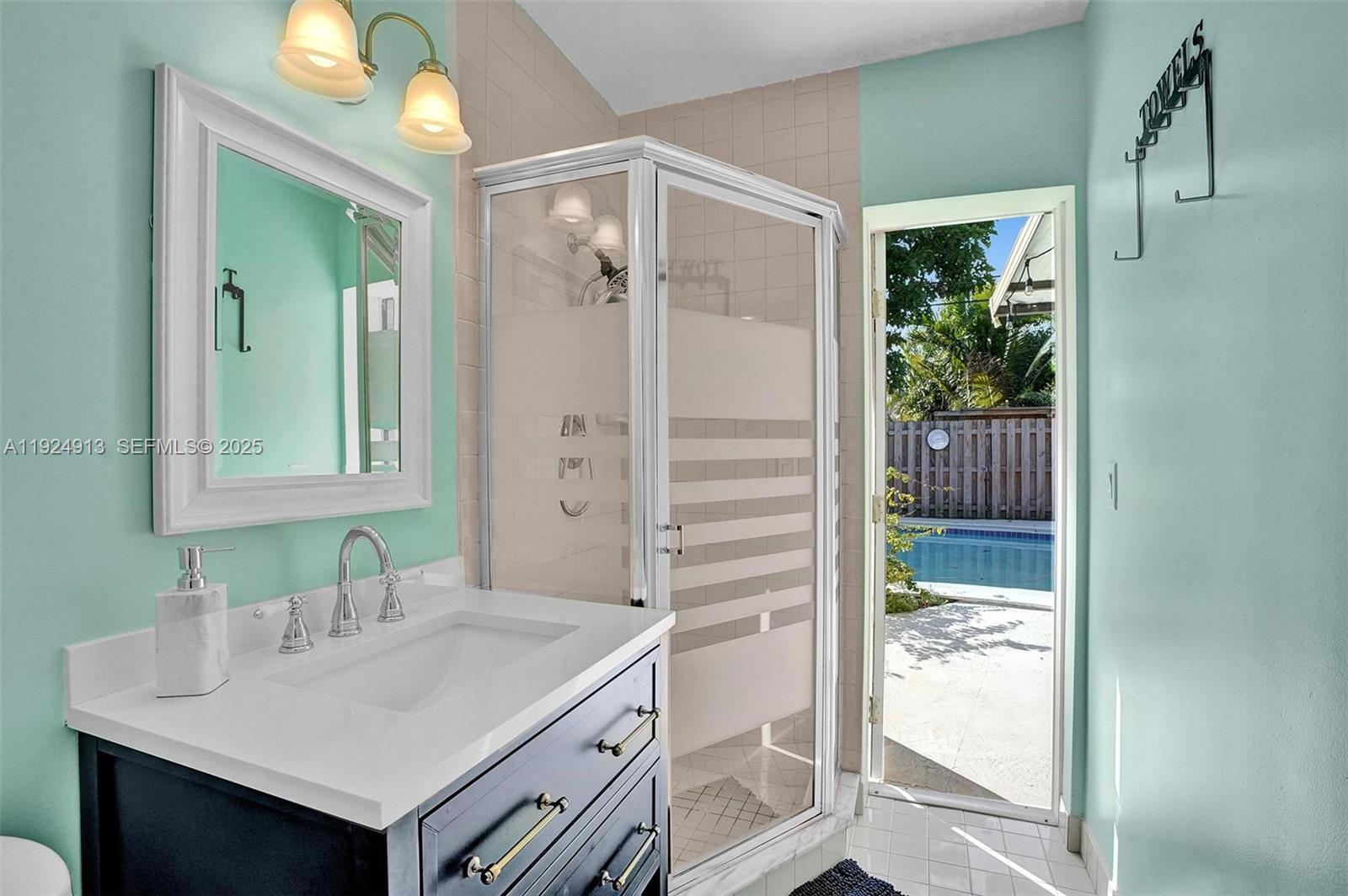 2620 Northeast 19th Street Pompano Beach, FL 33062 - Photo 18 of 42 a bathroom with a sink and a mirror