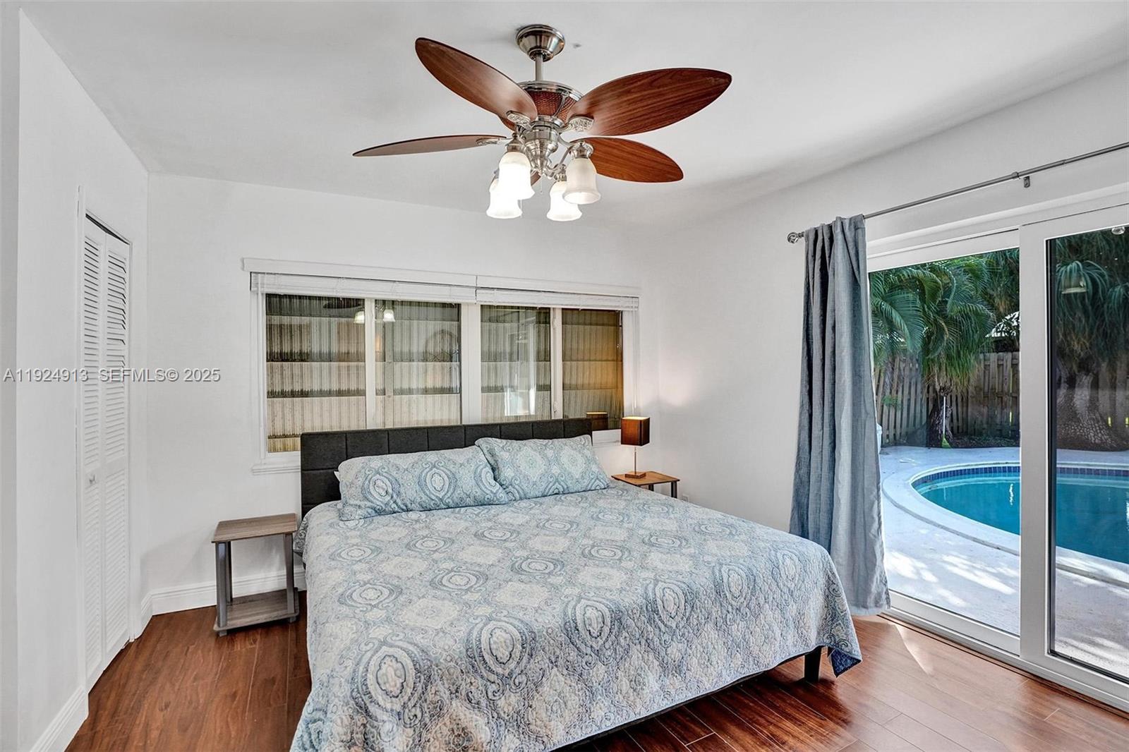 2620 Northeast 19th Street Pompano Beach, FL 33062 - Photo 19 of 42 a bedroom with a large bed and a large window