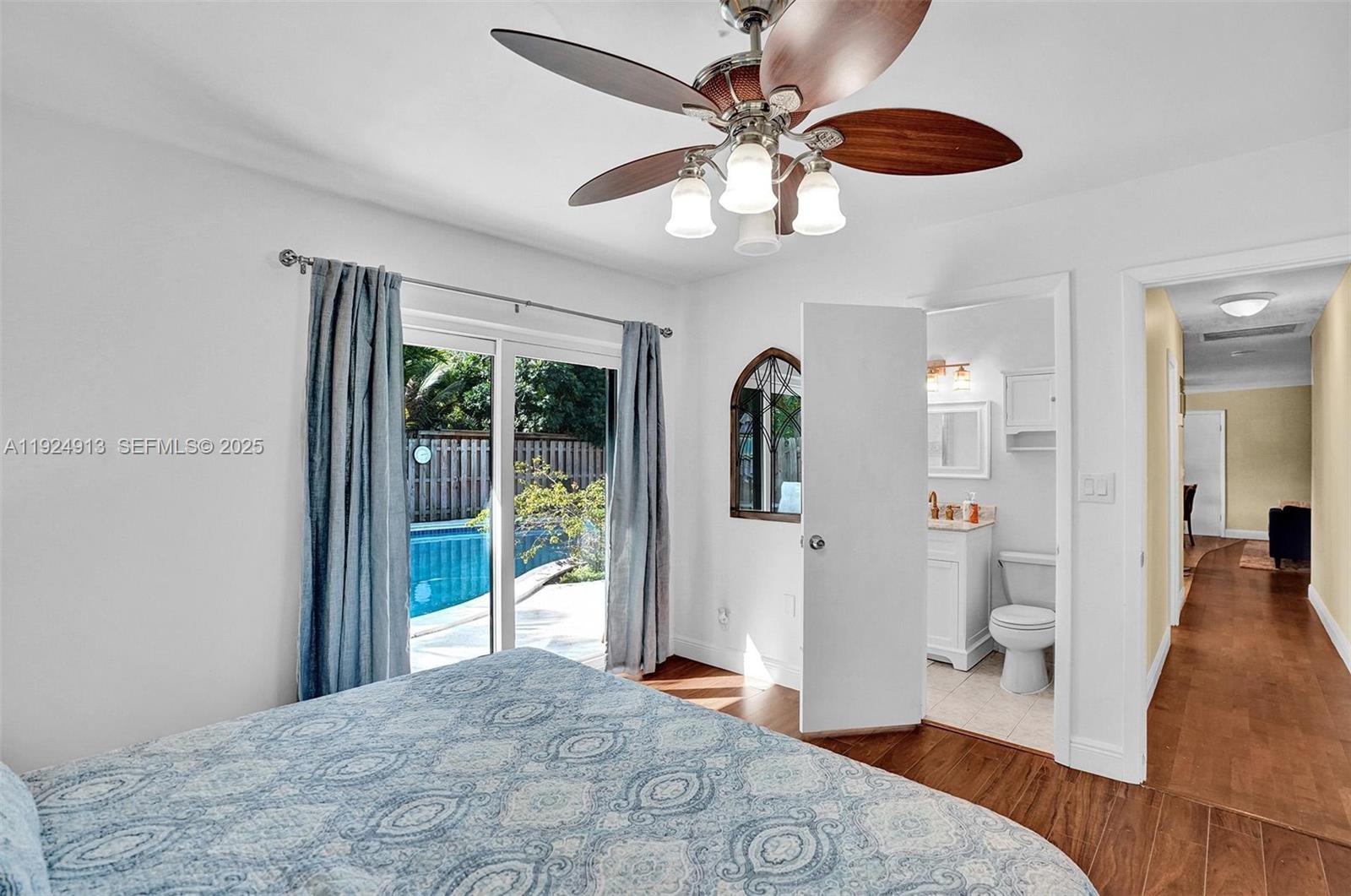 2620 Northeast 19th Street Pompano Beach, FL 33062 - Photo 20 of 42 a view of a livingroom with wooden floor and a ceiling fan