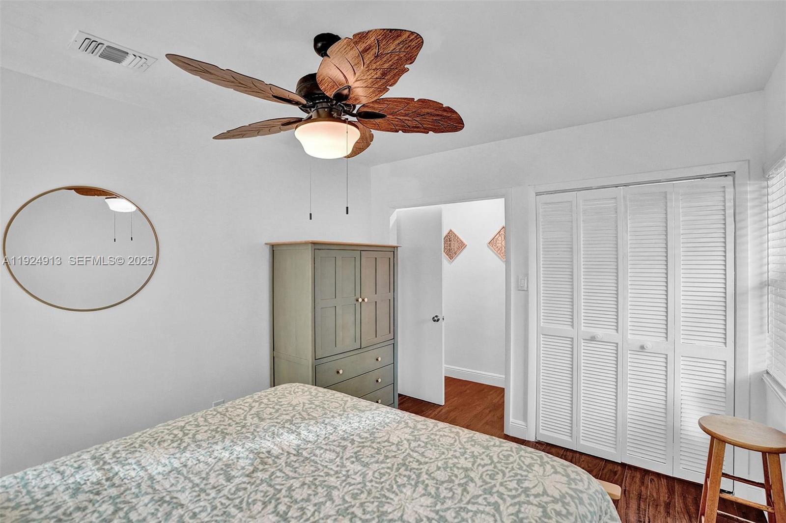 2620 Northeast 19th Street Pompano Beach, FL 33062 - Photo 22 of 42 a bedroom with a bed and a chandelier