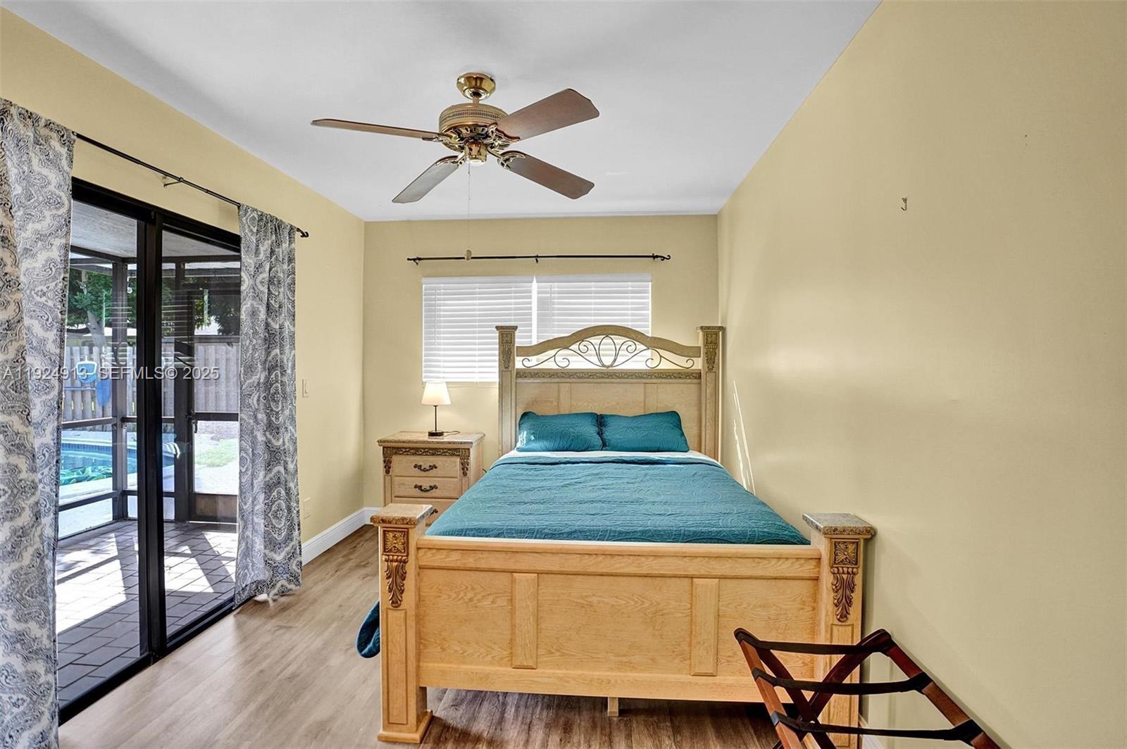 2620 Northeast 19th Street Pompano Beach, FL 33062 - Photo 26 of 42 a bedroom with a bed and wooden floor