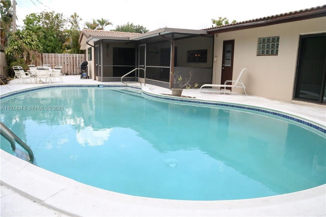 2620 Northeast 19th Street Pompano Beach, FL 33062 - Photo 3 of 42 a swimming pool with outdoor seating