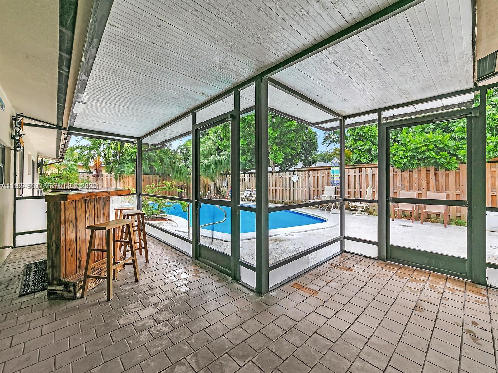 2620 Northeast 19th Street Pompano Beach, FL 33062 - Photo 35 of 42 a view of a porch with furniture and garden