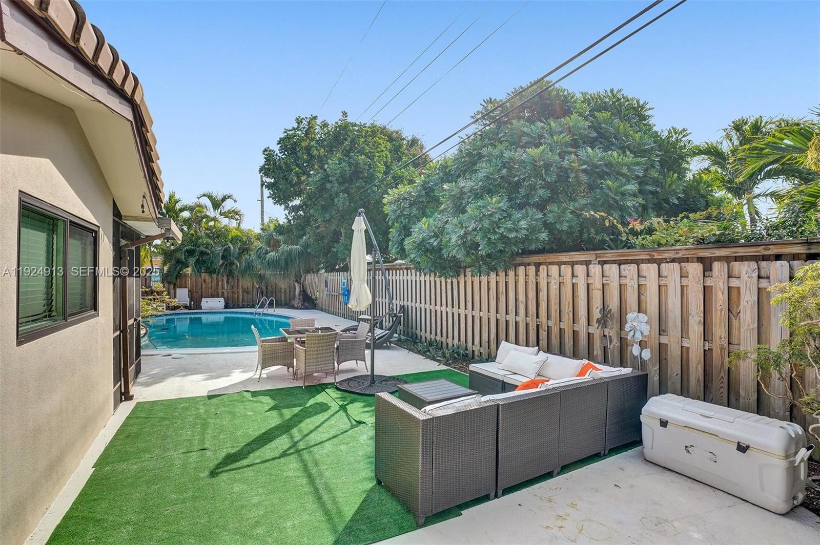 2620 Northeast 19th Street Pompano Beach, FL 33062 - Photo 36 of 42 a view of a chair and tables in the backyard