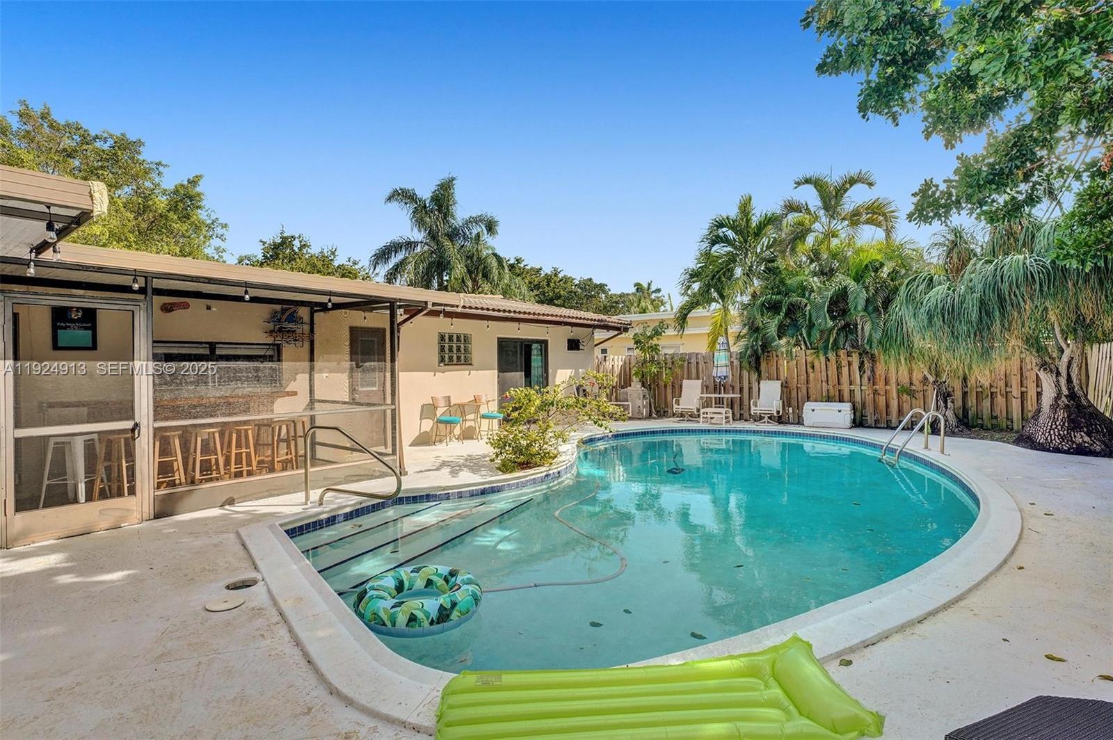 2620 Northeast 19th Street Pompano Beach, FL 33062 - Photo 37 of 42 a view of a house with swimming pool and sitting area
