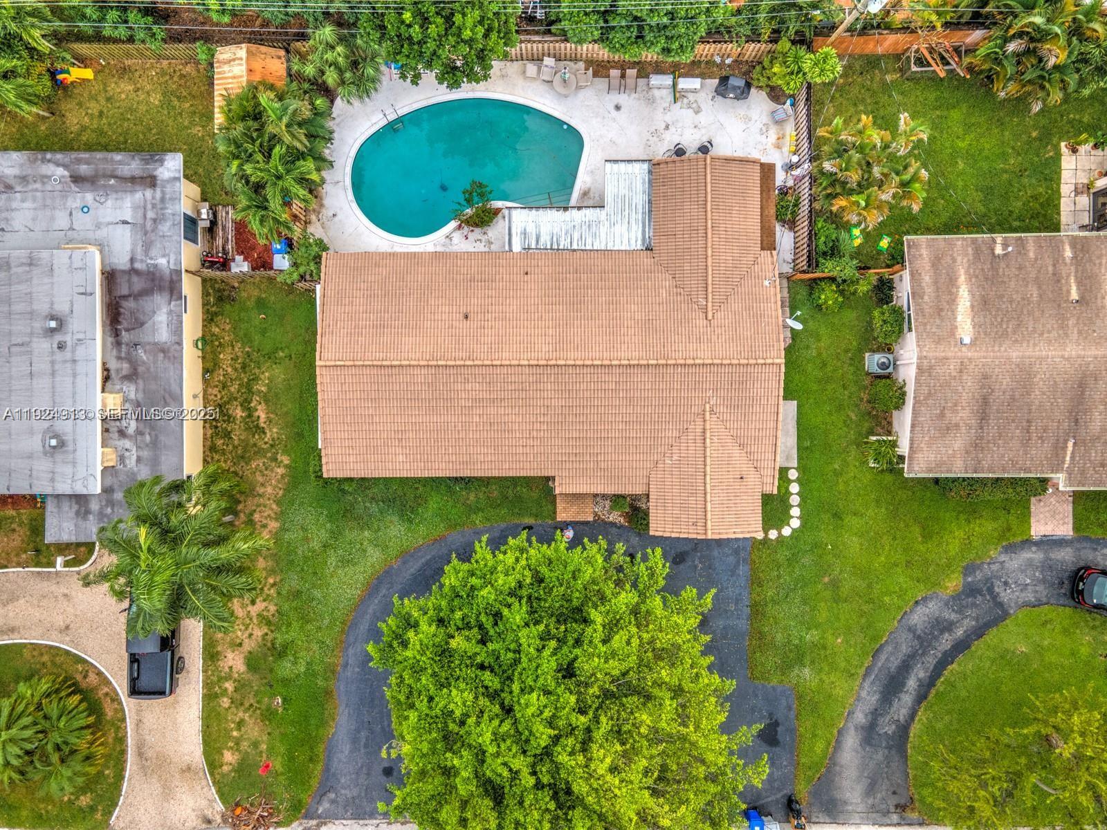 2620 Northeast 19th Street Pompano Beach, FL 33062 - Photo 41 of 42 an aerial view of a house with a swimming pool outdoor seating and yard