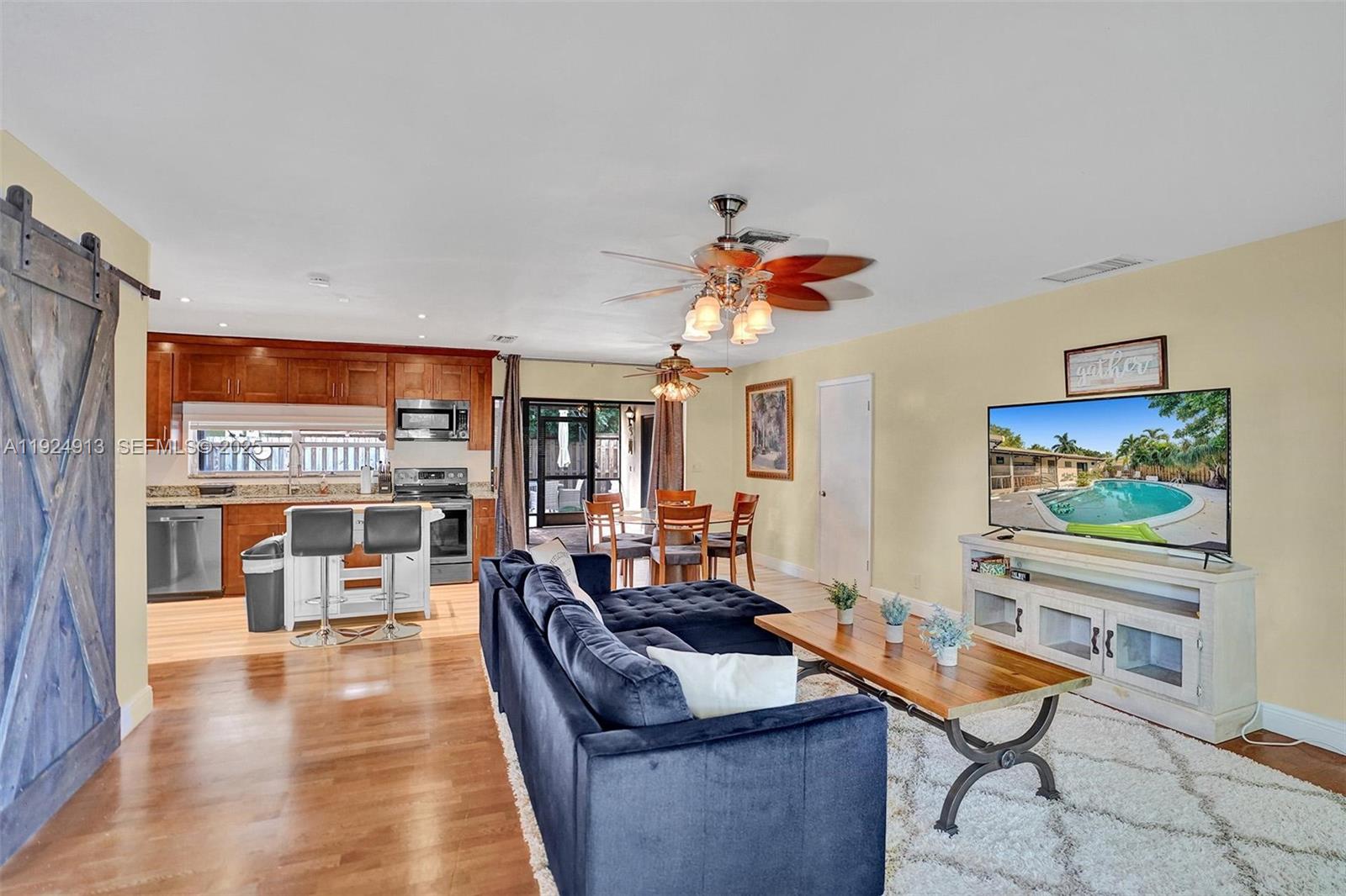 2620 Northeast 19th Street Pompano Beach, FL 33062 - Photo 5 of 42 a living room with furniture and a flat screen tv