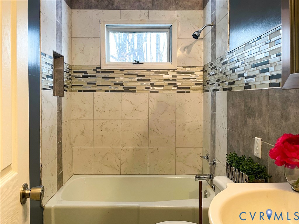 3867 Longview Road Kenbridge, VA 23944 - Photo 17 of 25 a bathroom with a tub a sink and a window
