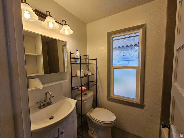 744 Royal Street Helper, UT 84526 - Photo 15 of 33 Bathroom with a textured wall and vanity