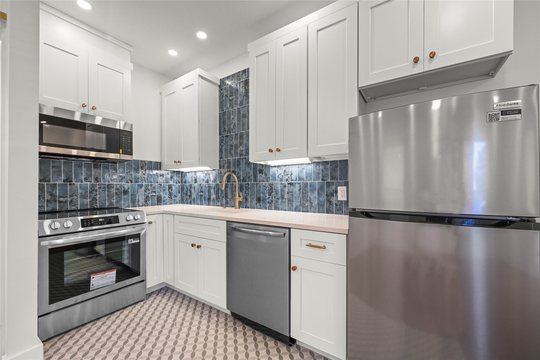 a kitchen with stainless steel appliances a refrigerator sink and cabinets