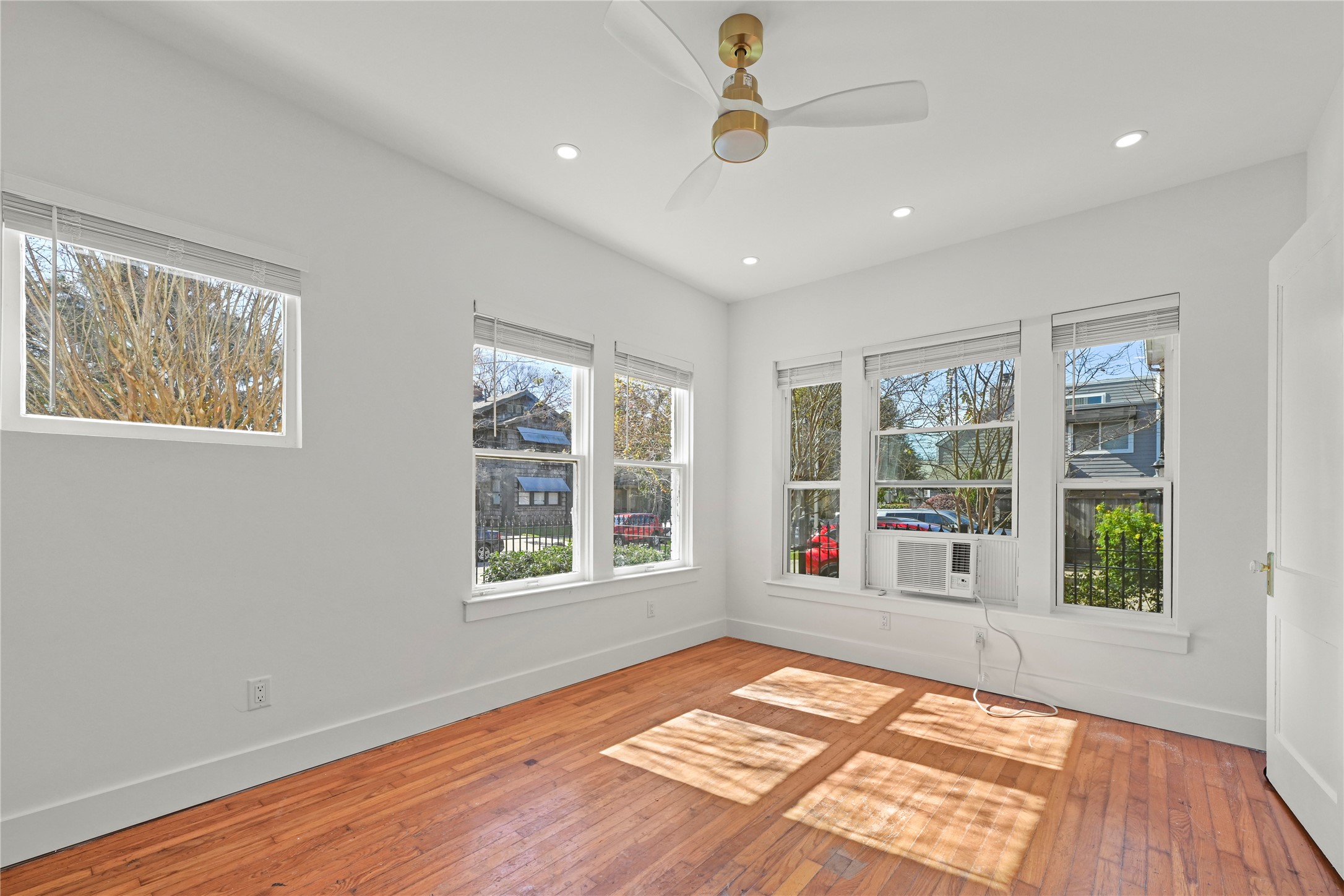 808 Sul Ross Street, Unit 2 Houston, TX 77006 - Photo 4 of 11 a view of an empty room with a window and wooden floor