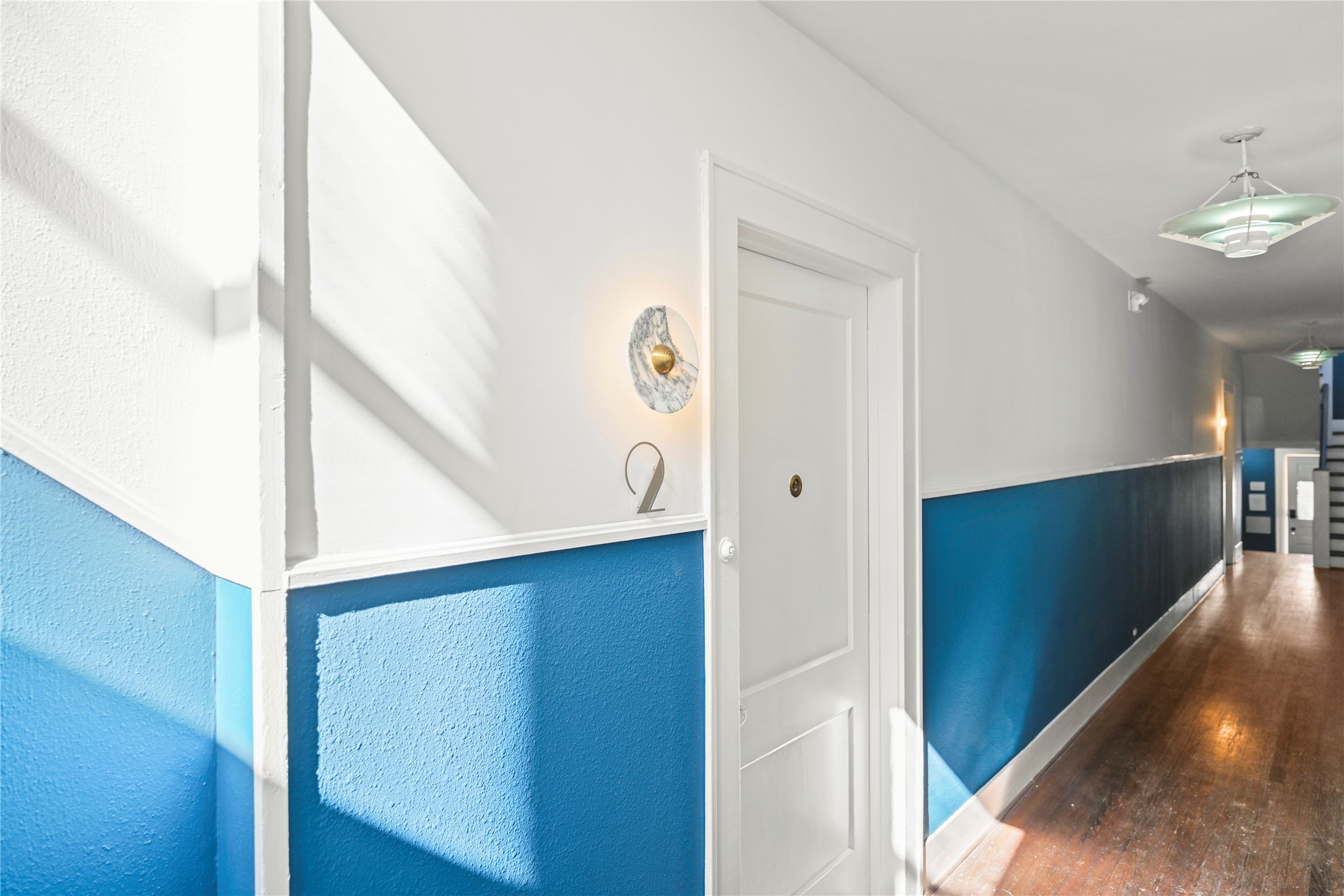 808 Sul Ross Street, Unit 2 Houston, TX 77006 - Photo 5 of 11 a view of a hallway with entryway wooden floor and front door