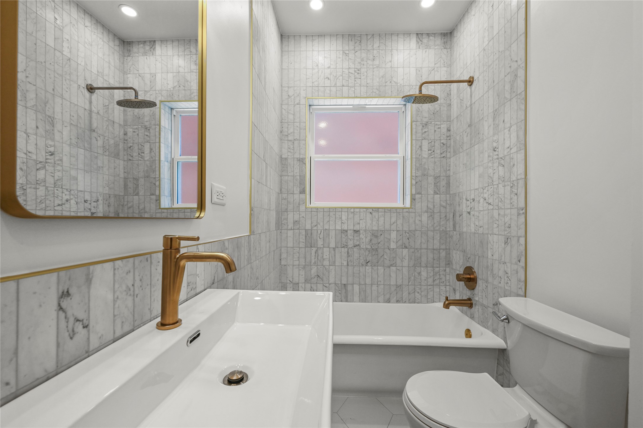 808 Sul Ross Street, Unit 2 Houston, TX 77006 - Photo 7 of 11 a bathroom with a bathtub shower sink vanity mirror and toilet